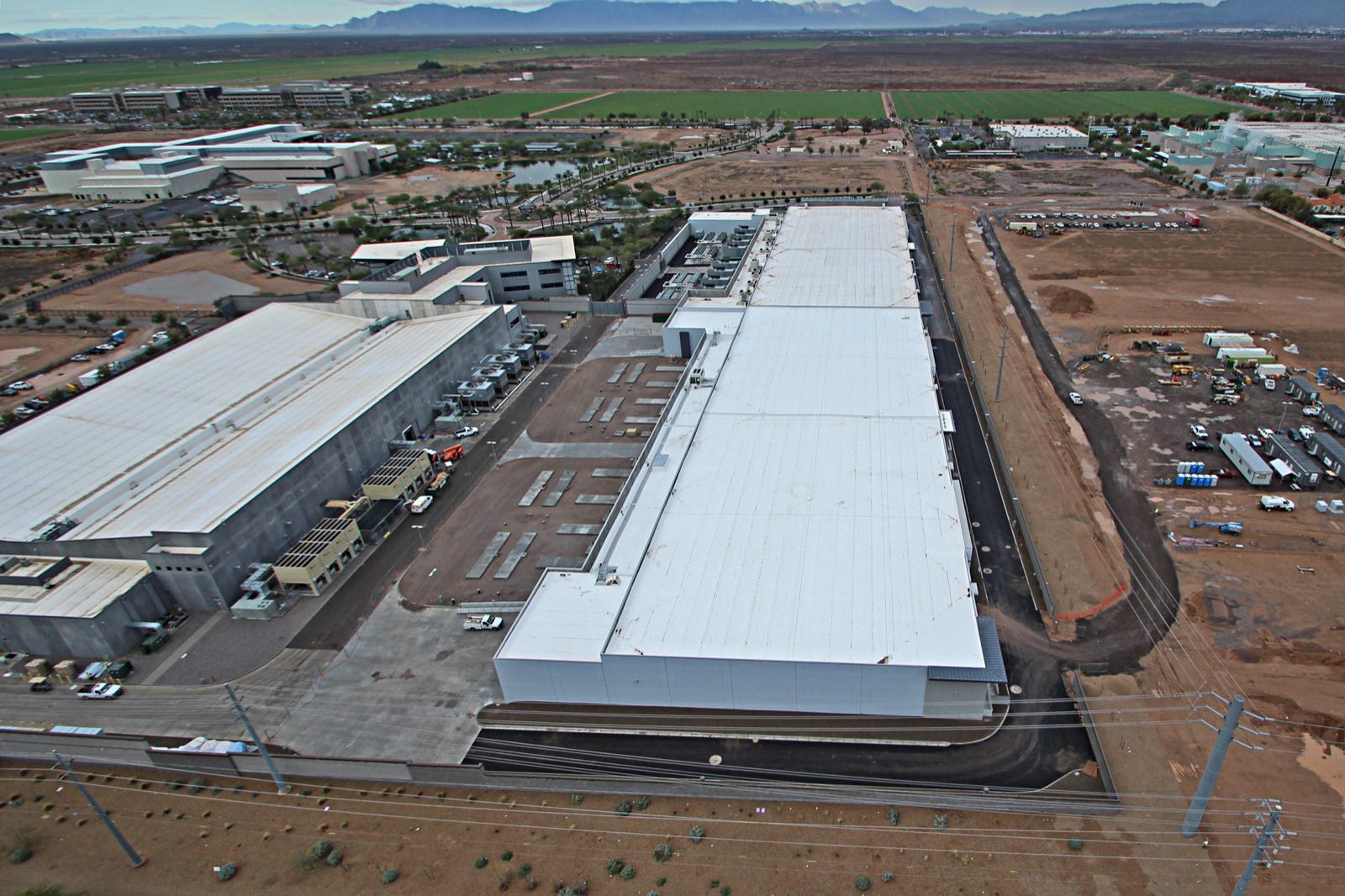 Aerial view of a large white commercial roof on a data center campus in the Phoenix area